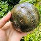 Sideways view of Grade AA Ocean Jasper polished sphere, often paired with practices around Emotional Healing, from Madagascar.