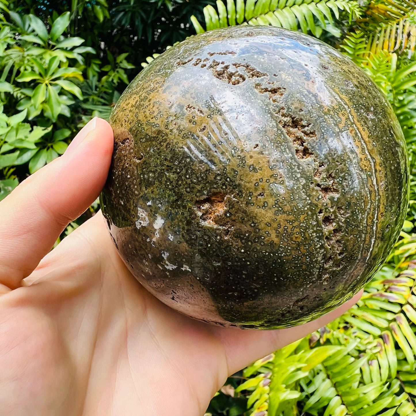 Sideways view of Grade AA Ocean Jasper polished sphere, often paired with practices around Emotional Healing, from Madagascar.