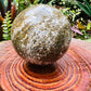 Detail shot of Grade AA Ocean Jasper sphere under natural light
