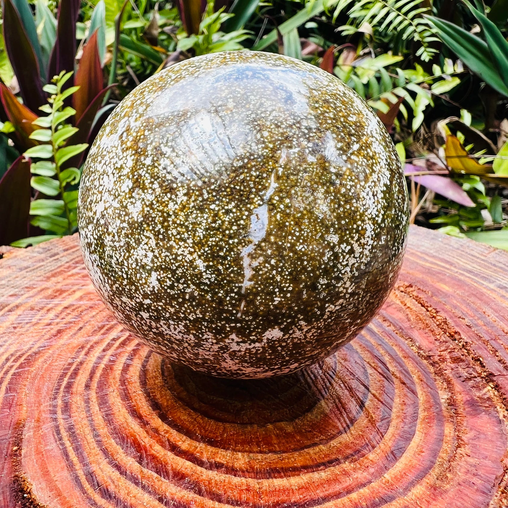 Up-close view of Ocean Jasper polished sphere, showing natural sheen.