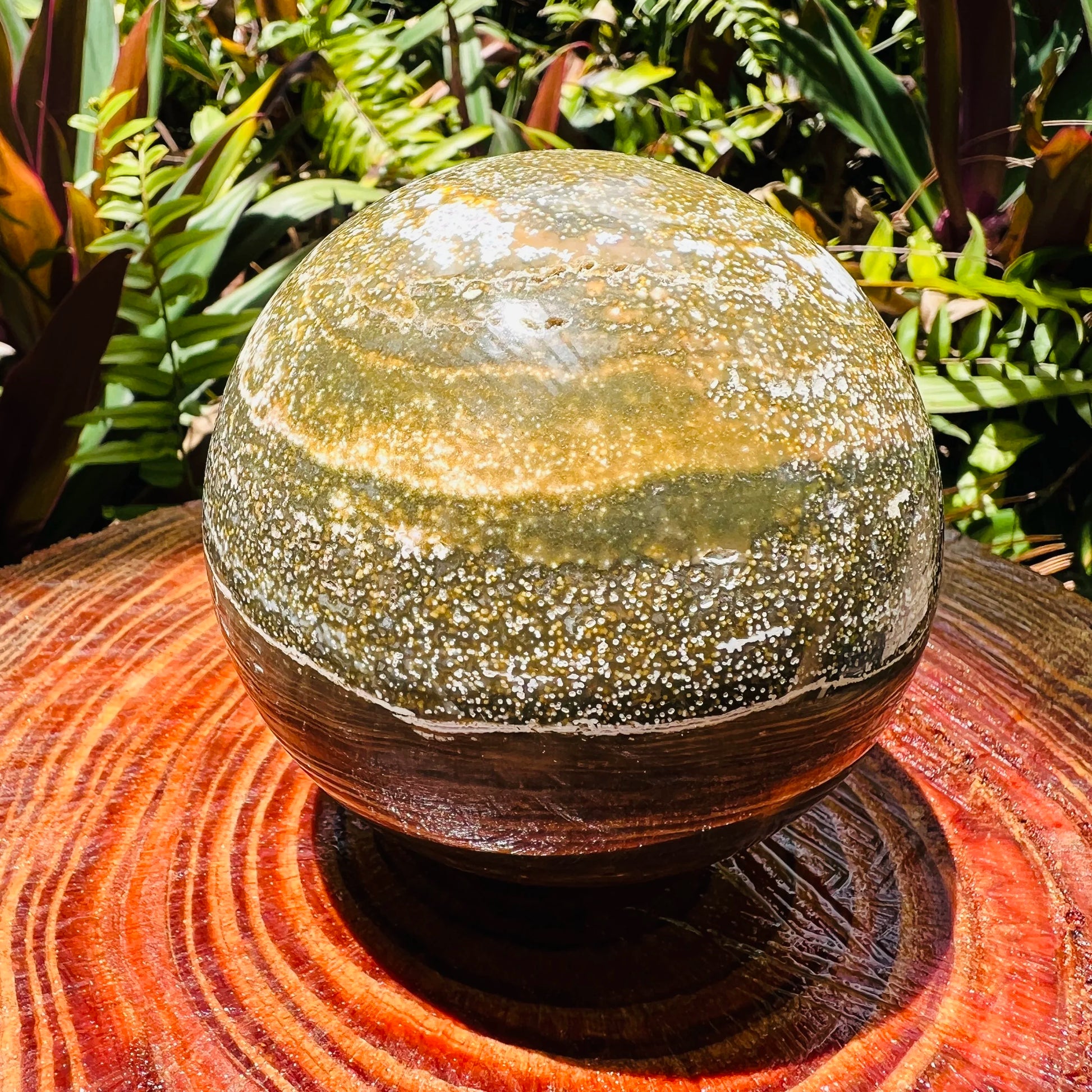 Color detail of green Ocean Jasper polished sphere, showing natural inclusions, drawn on for Emotional Healing and Stress Relief.