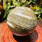 Edge-on view of Grade AA Ocean Jasper polished sphere, showing matte finish, sourced from Madagascar.