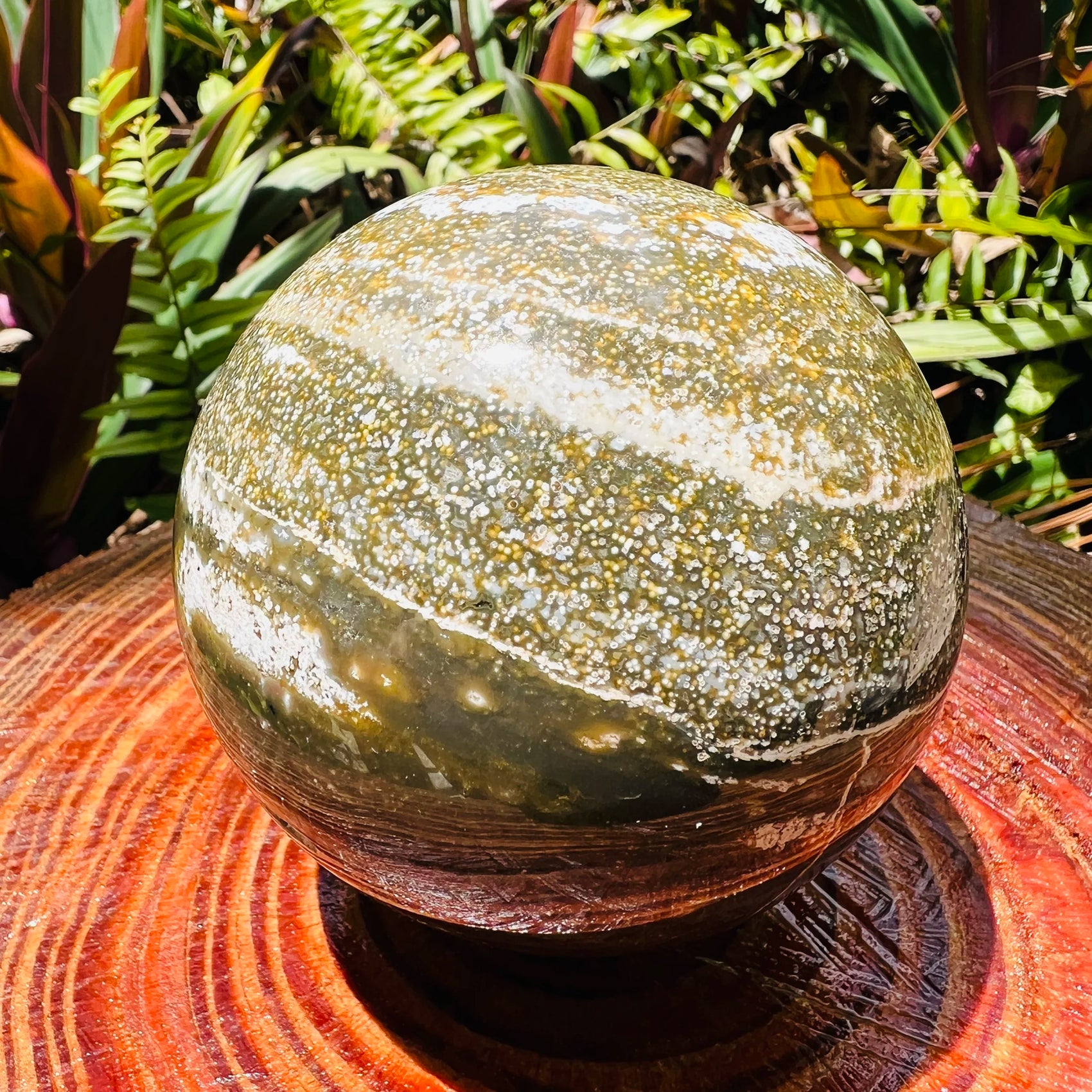 Edge-on view of Grade AA Ocean Jasper polished sphere, showing matte finish, sourced from Madagascar.