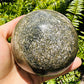Detail shot of Grade AA Ocean Jasper sphere under natural light