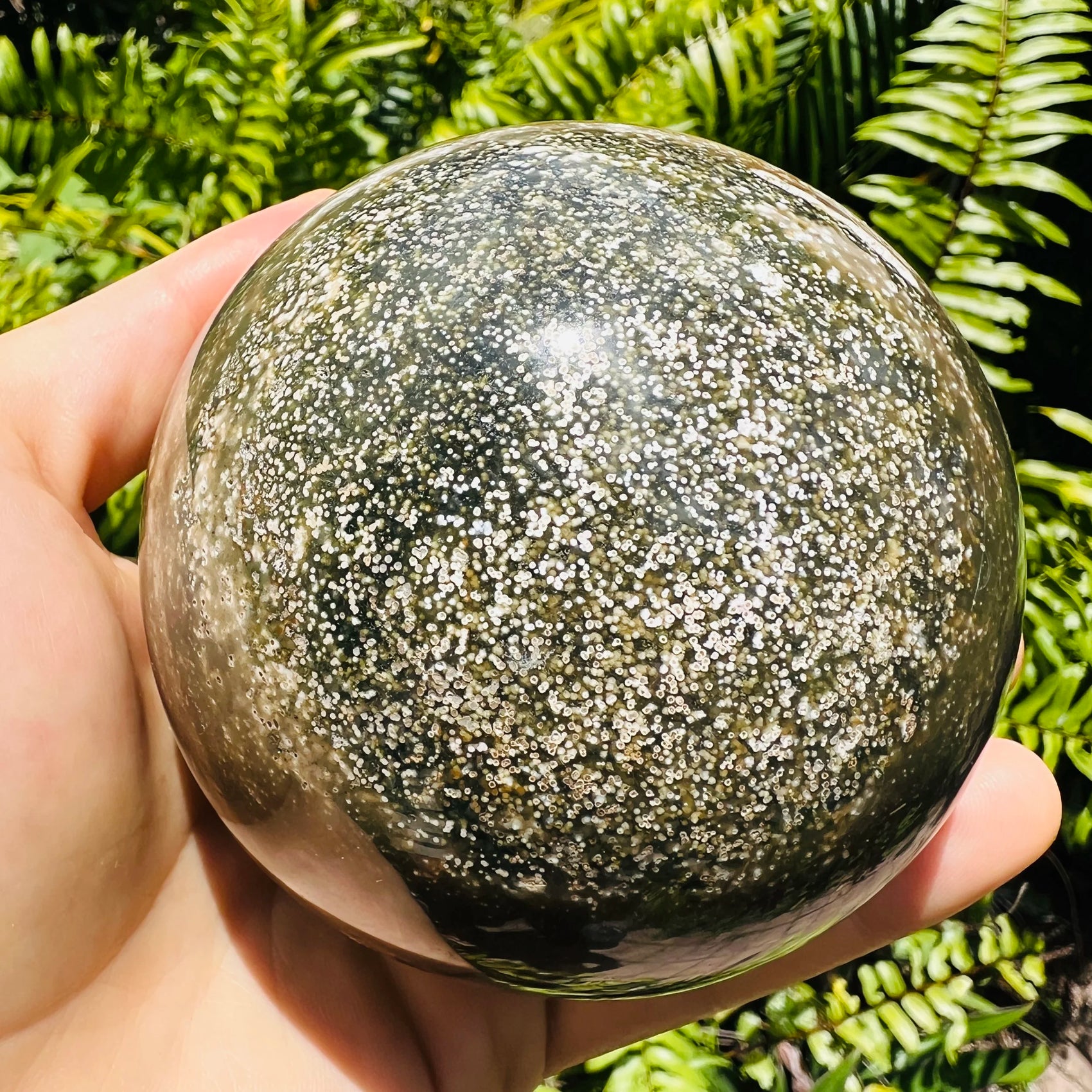 Detail shot of Grade AA Ocean Jasper sphere under natural light