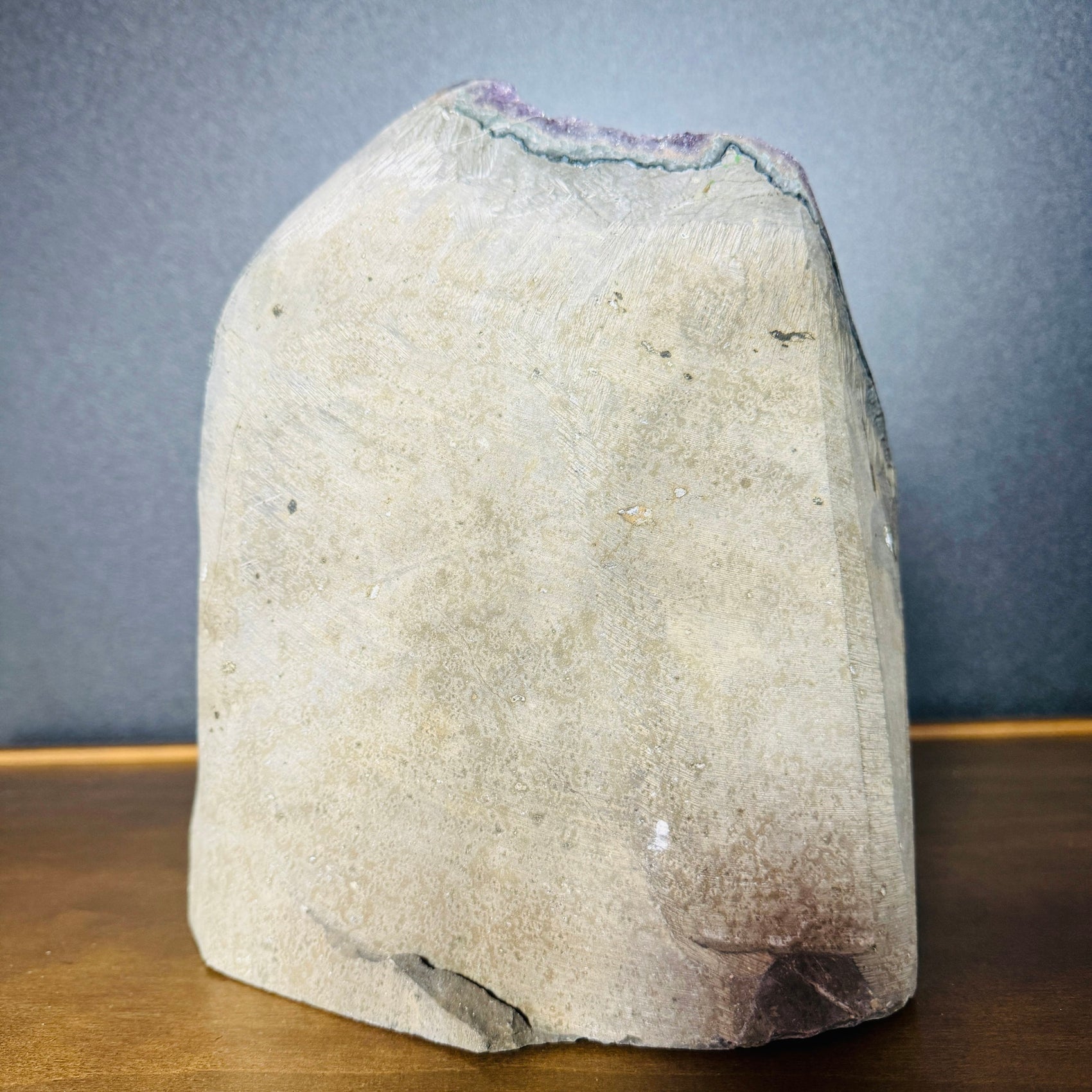 Grade aa amethyst geode held in hand for size reference