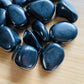 Close-up of Shungite tumbled stone from Russia, soothing wellness stone for Stress Relief
