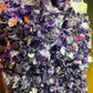 Grade aa amethyst geode held in hand for size reference