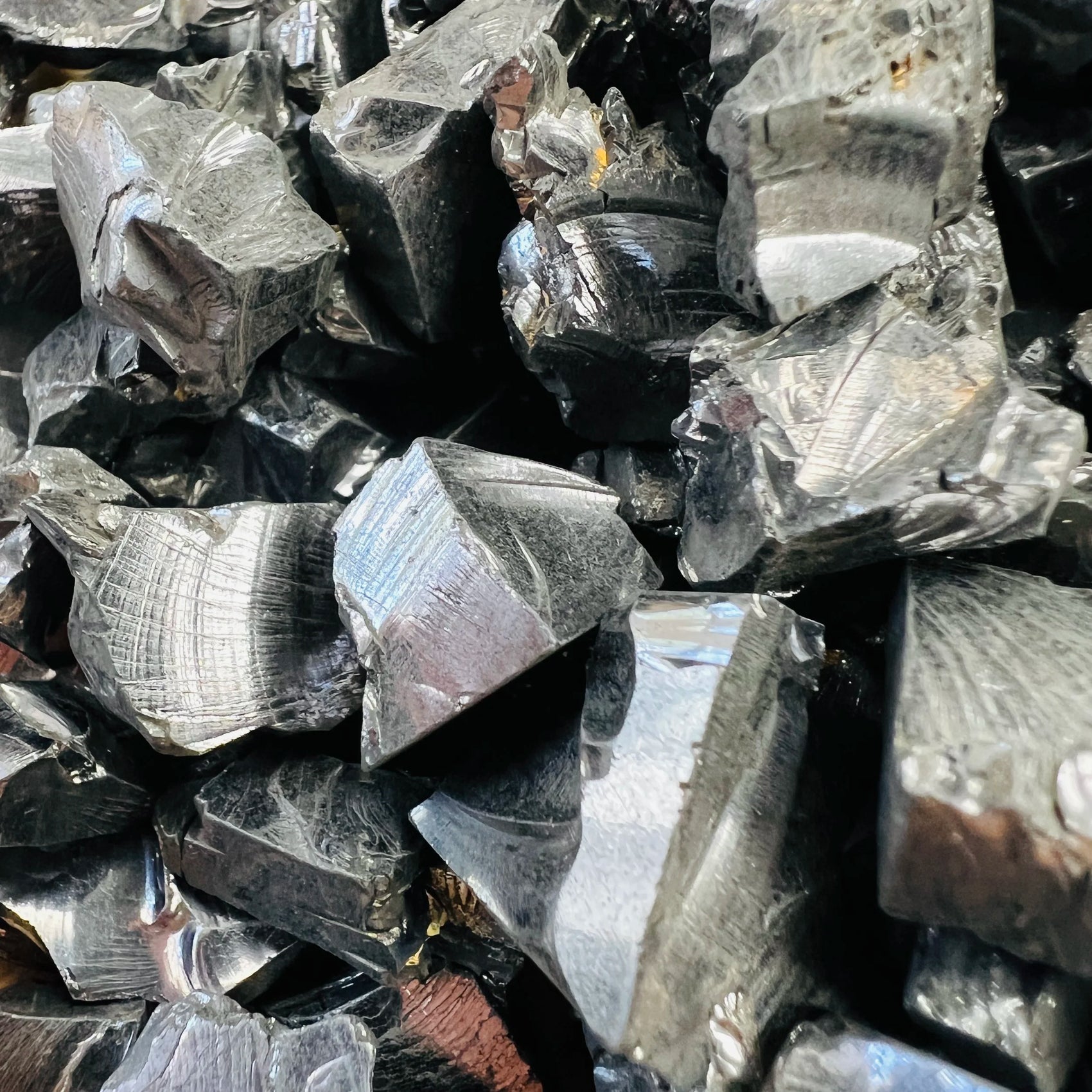 Top-down shot of Shungite raw stone, sourced from Republic of Karélia, Russia.