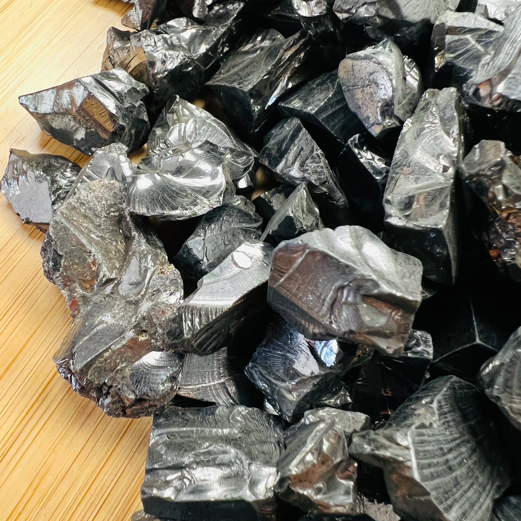 Profile shot of Shungite raw stone, showing natural patina, sourced from Republic of Karélia, Russia.
