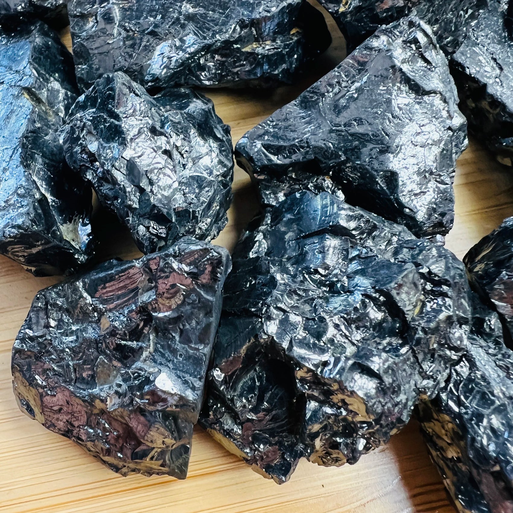 Profile shot of black Shungite raw stone, showing tight grain, often paired with practices around Protection and Cleansing.