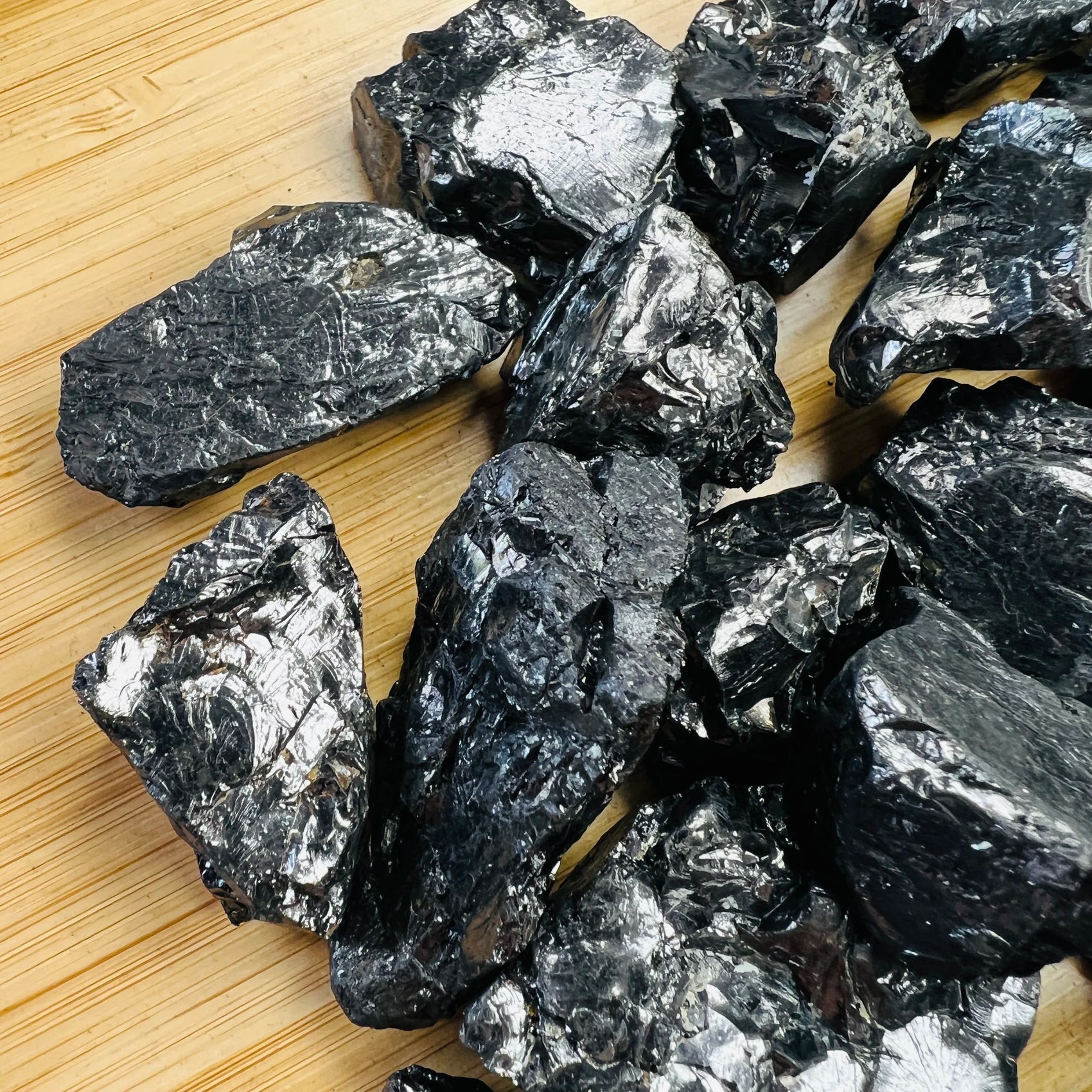 Held in hand, a Shungite raw stone, sourced from Republic of Karélia, Russia.