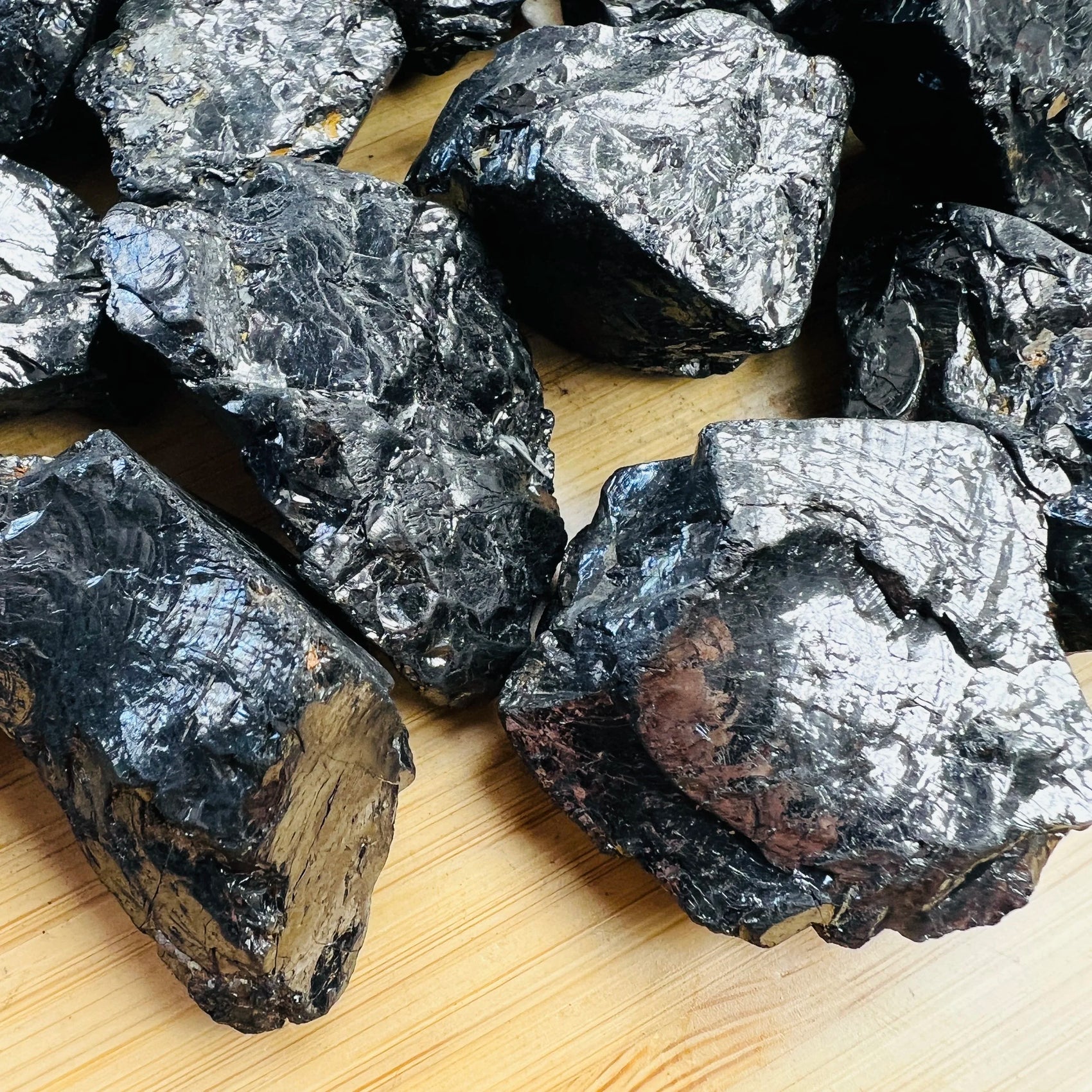 Edge-on view of Shungite raw stone, showing natural inclusions.