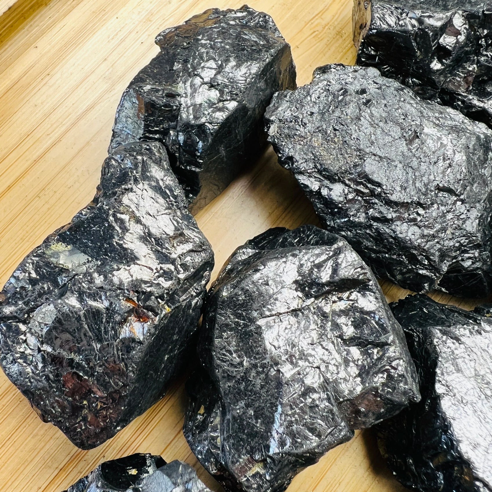 Rear view of Shungite raw stone, sourced from Russia, often paired with practices around Protection.