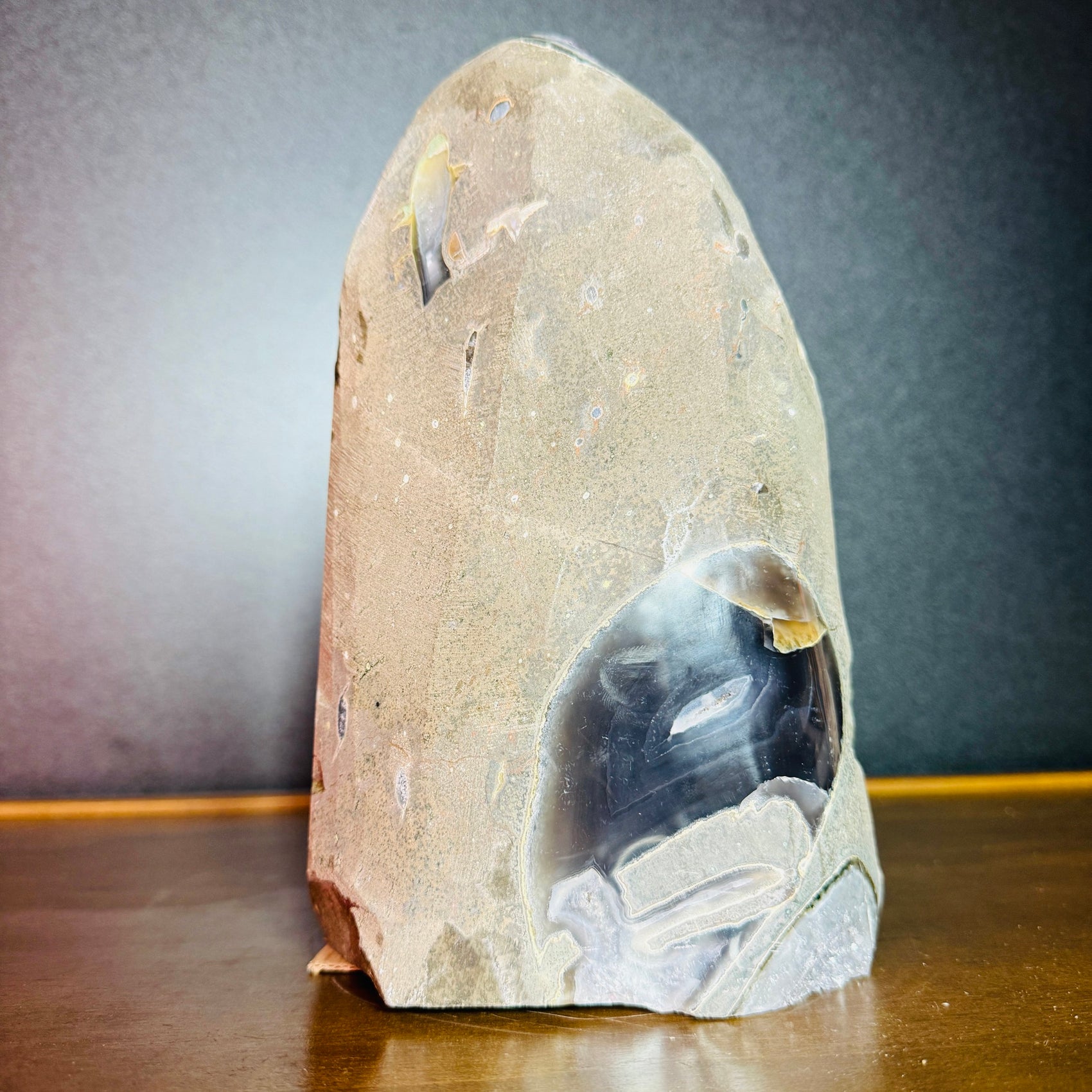 Grade aa amethyst geode held in hand for size reference