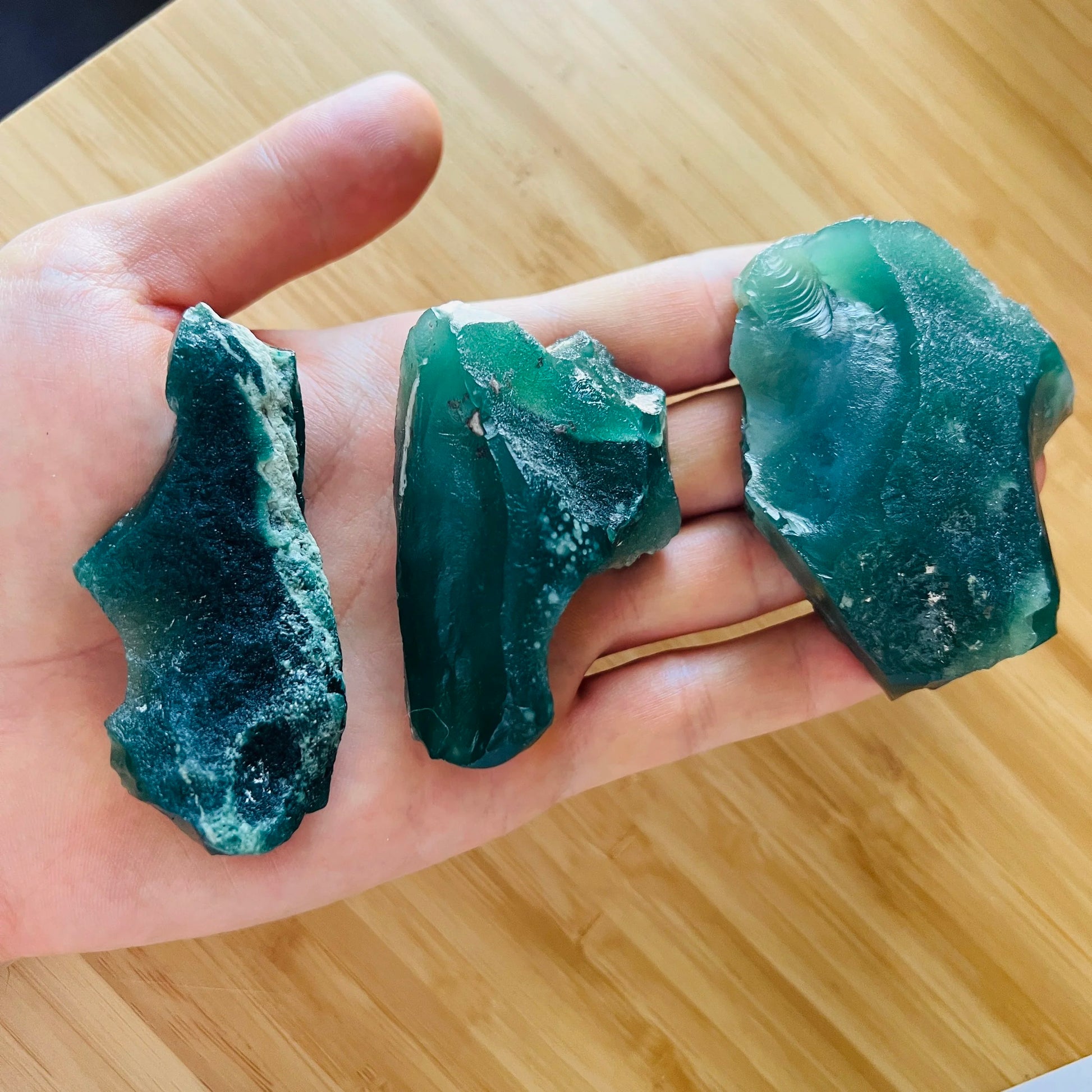 Grade a chalcedony raw held in hand for size reference