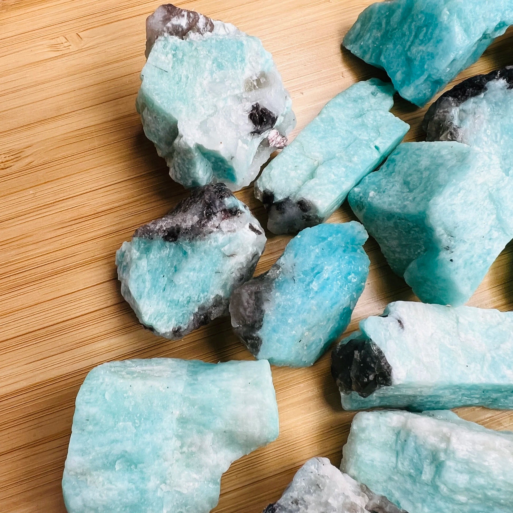 Overhead view of Grade AA Amazonite raw stone, hand-selected from Amboasitra, Madagascar, worked with for Stress Relief.