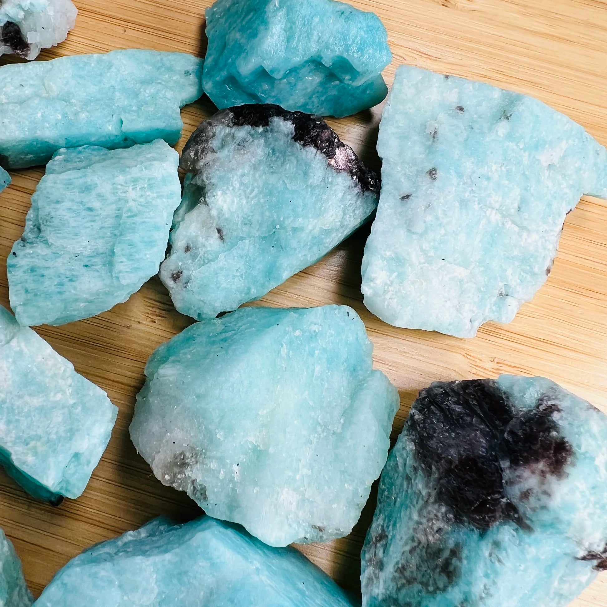 Hand-held view of a single Amazonite raw stone hand-selected from Amboasitra, Madagascar.