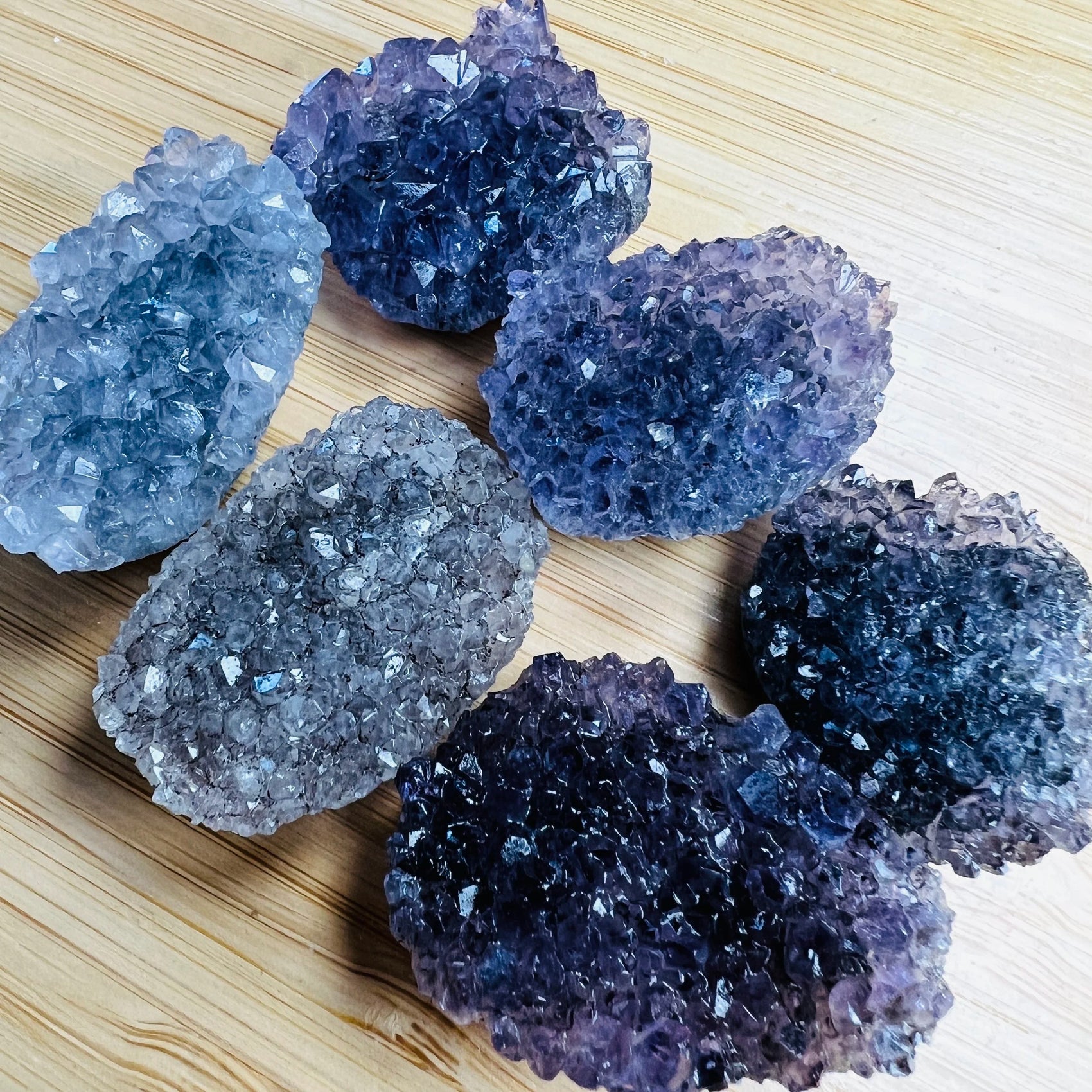 Side profile of Amethyst raw cabochon, showing raw matrix.