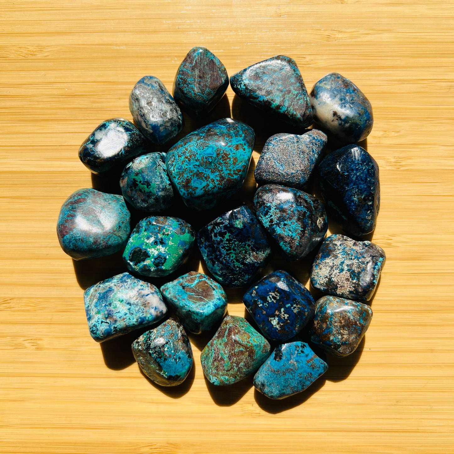 Resting display of Azurite tumbled stone, from Kunene, Namibia, traditionally used for Intuition, set to give a sense of weight.