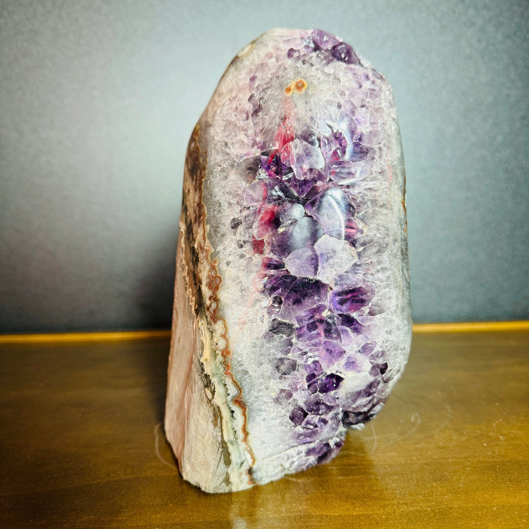 Grade aa amethyst geode held in hand for size reference