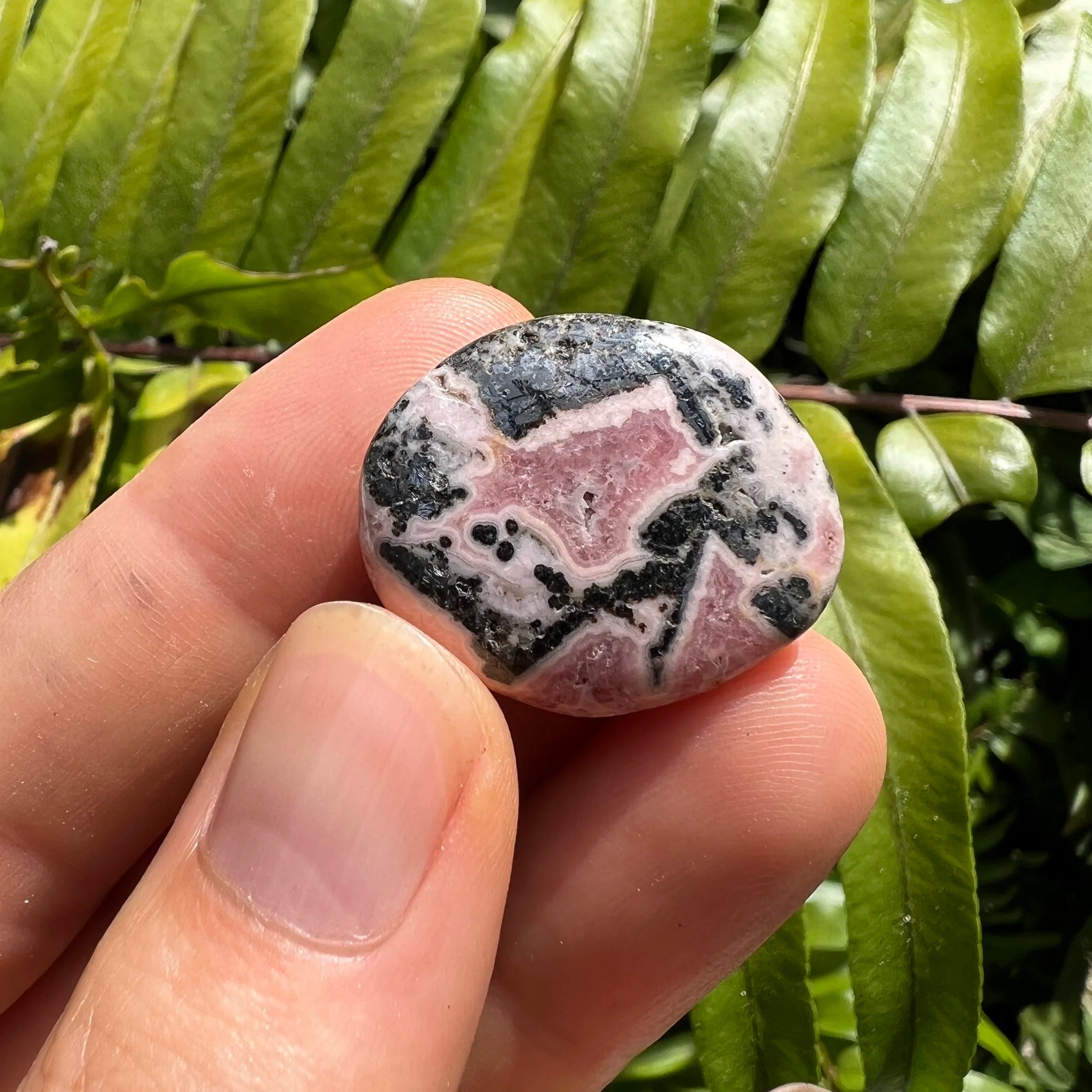 Full profile of Grade A Rhodochrosite tumbled stone ready to ship from Beyond Bohemian
