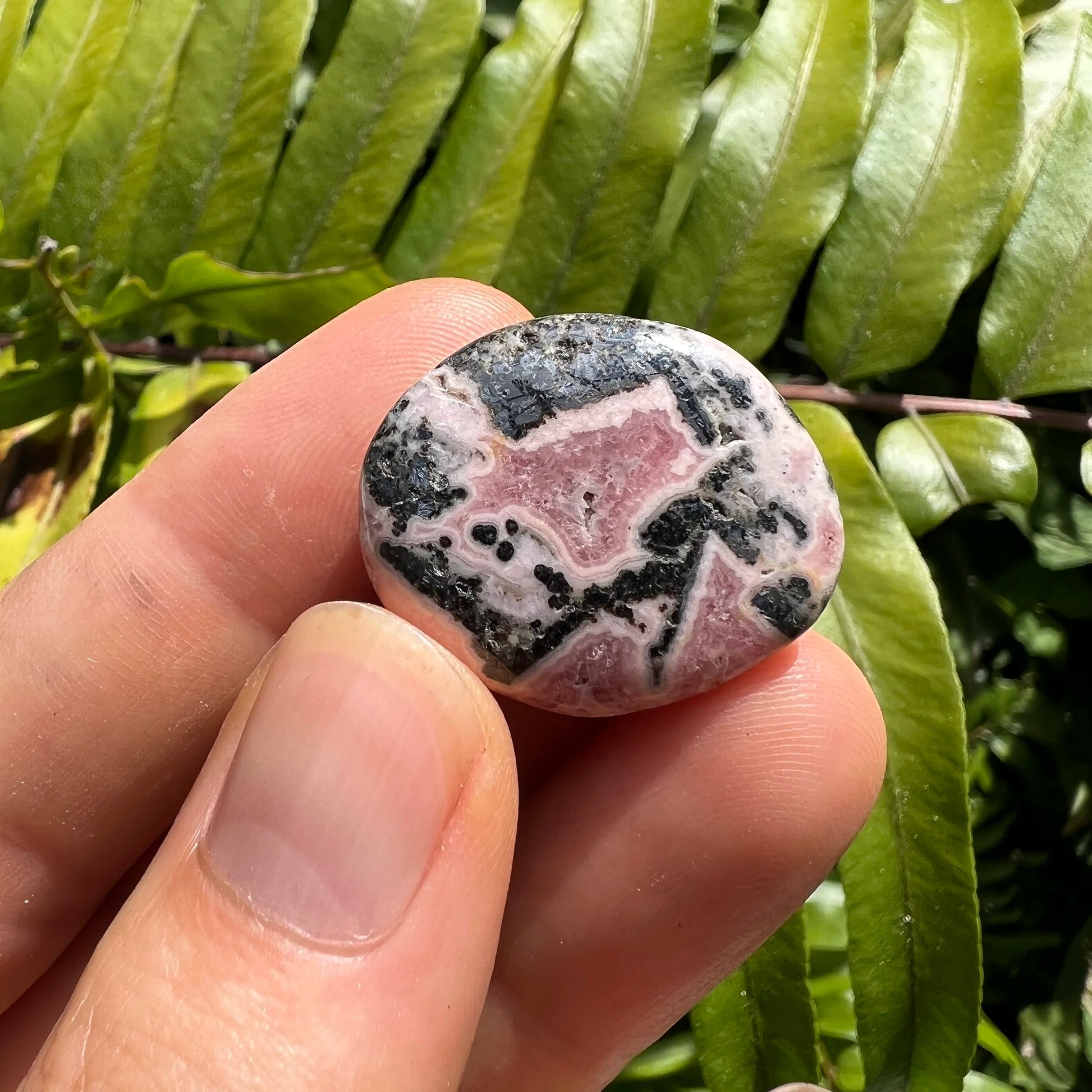 Full profile of Grade A Rhodochrosite tumbled stone ready to ship from Beyond Bohemian