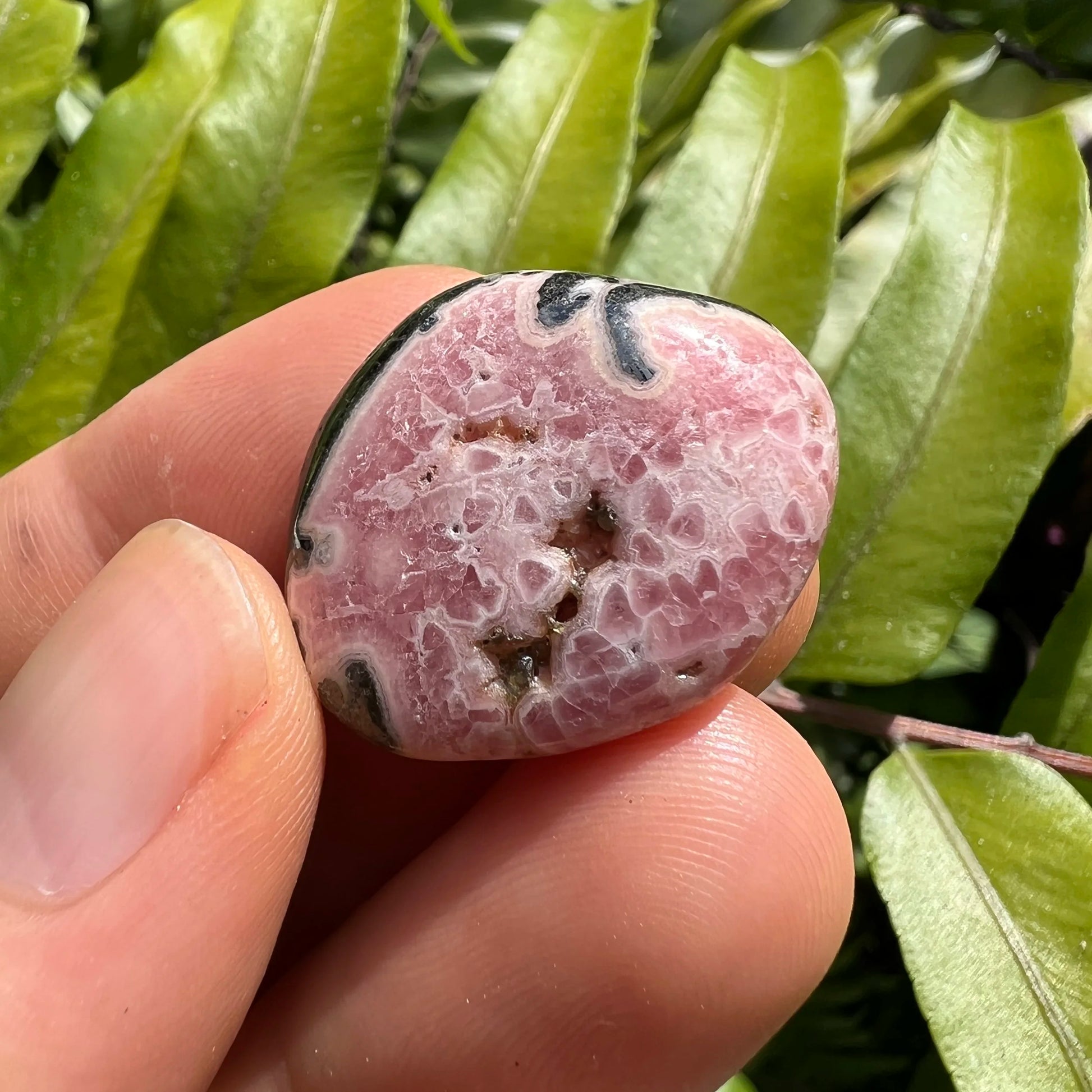 Full profile of Grade A Rhodochrosite tumbled stone ready to ship from Beyond Bohemian