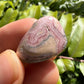 Full profile of Grade A Rhodochrosite tumbled stone ready to ship from Beyond Bohemian
