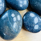 Profile shot of Lazulite palm stone, drawn on for Intuition and Meditation.