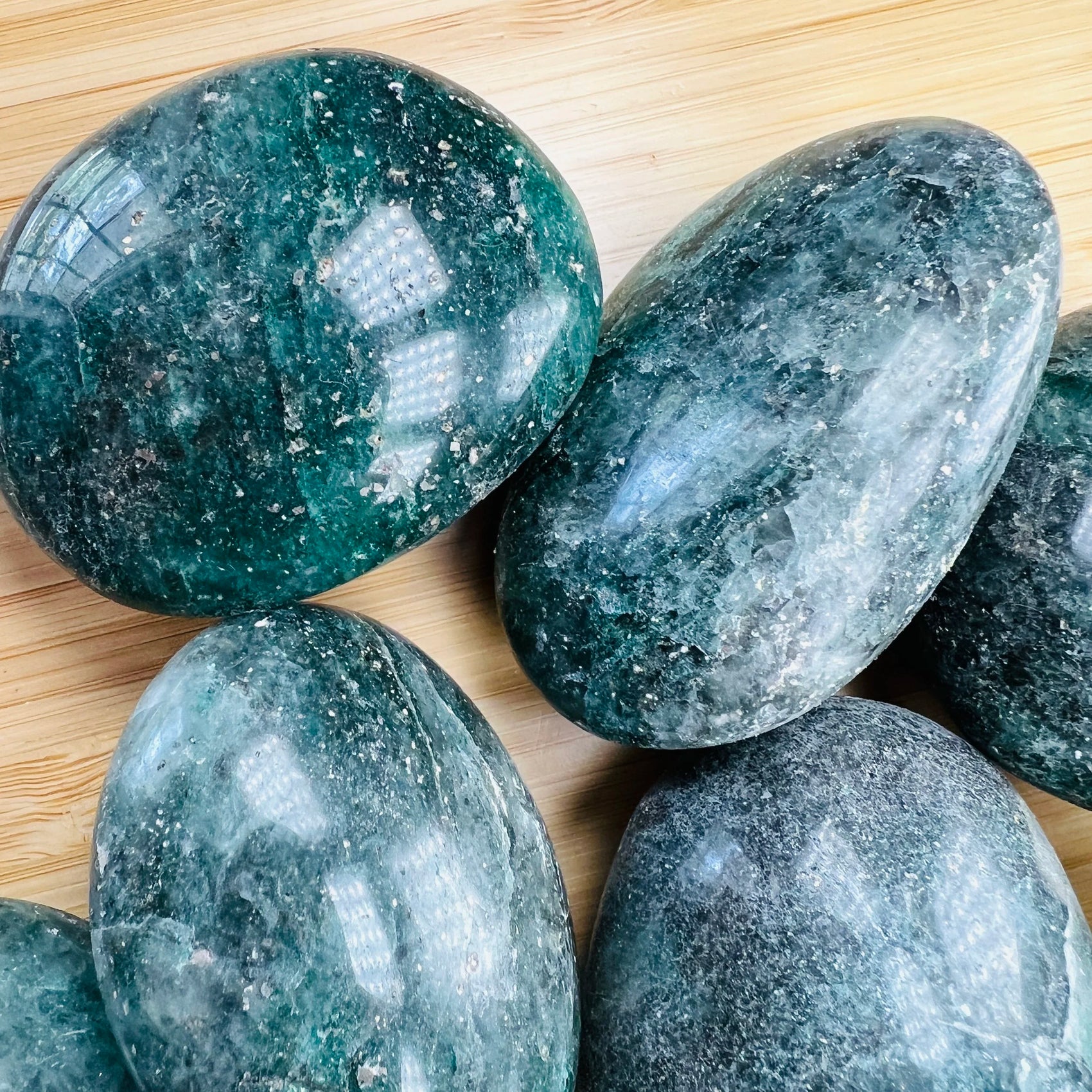 Rear view of green Fuchsite palm stone, showing characteristic finish.