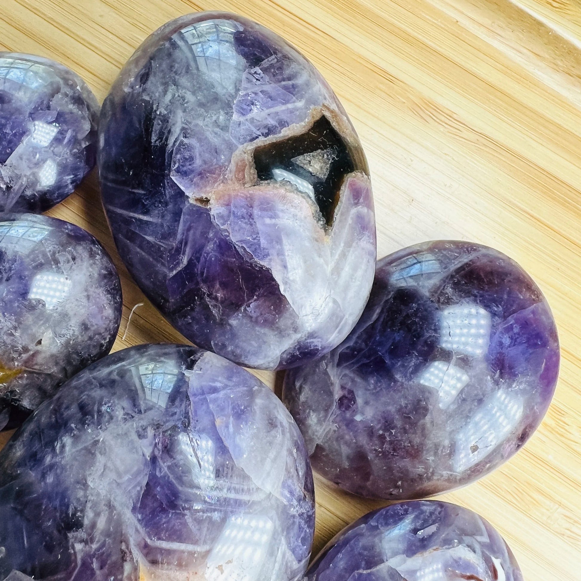 Underside detail of Grade AA Chevron Amethyst palm stone, showing characteristic patterning, linked to Intuition.