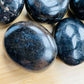 Side perspective of Iolite palm stone, showing natural sheen, from Madagascar.
