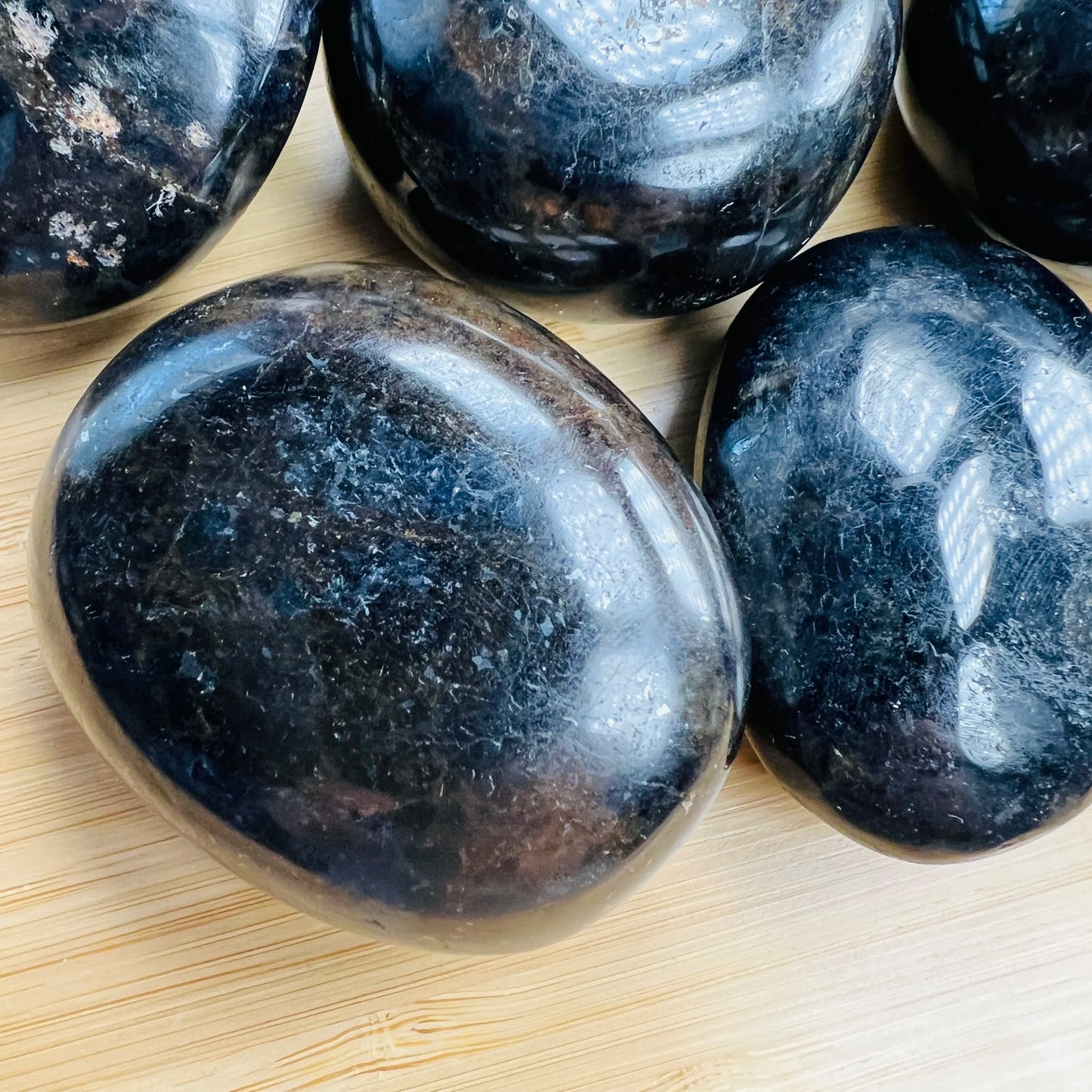 Side perspective of Iolite palm stone, showing natural sheen, from Madagascar.