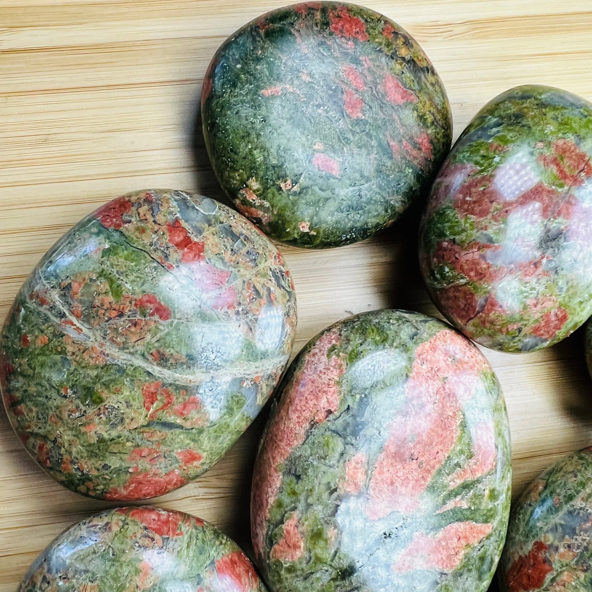 Side perspective of Unakite palm stone, traditionally used for Emotional Healing.