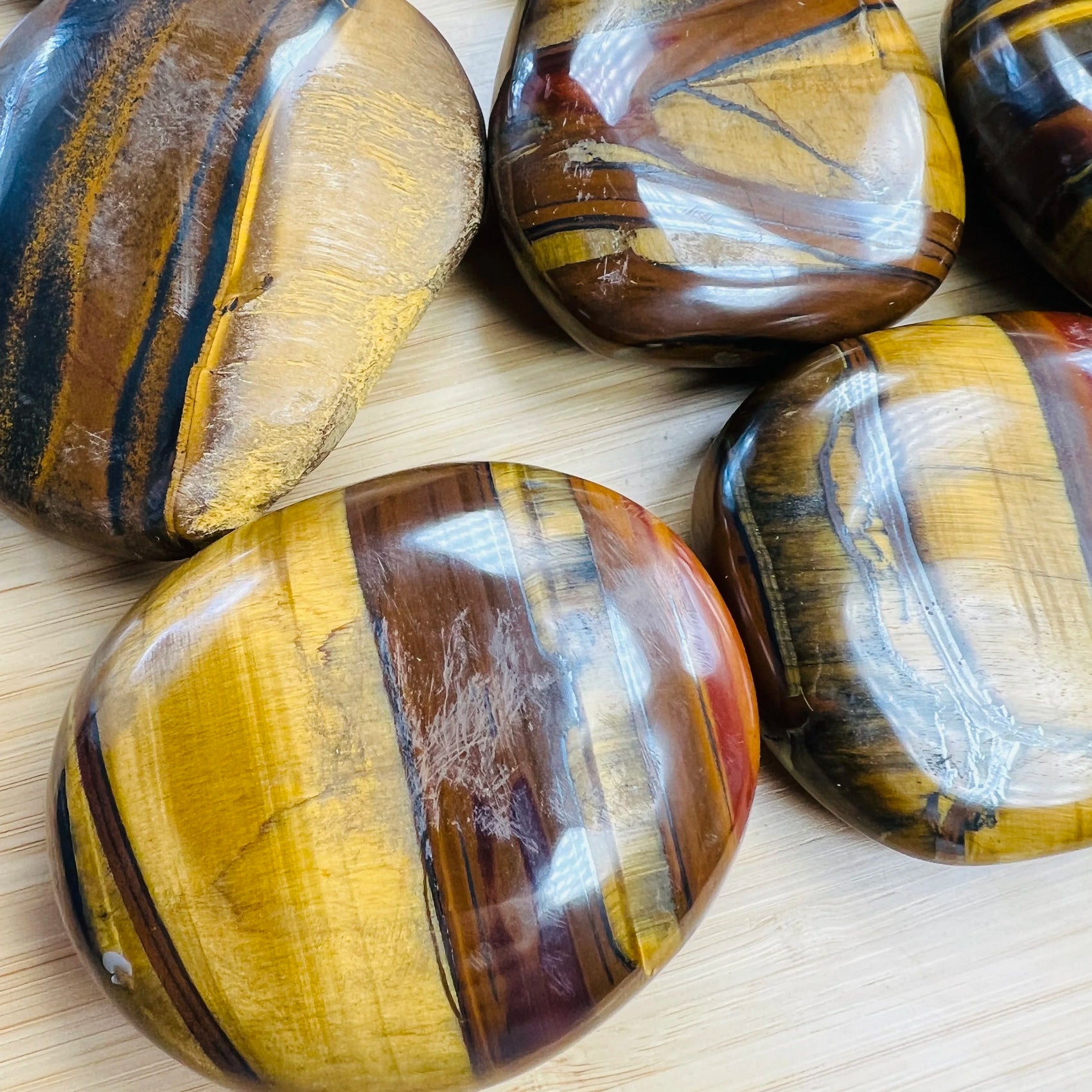 Close detail of brown Tiger Eye palm stone, often kept for Confidence and Career.