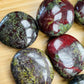 Edge view of green Dragon Bloodstone palm stone, hand-selected from Limpopo, South Africa, worked with for Confidence.