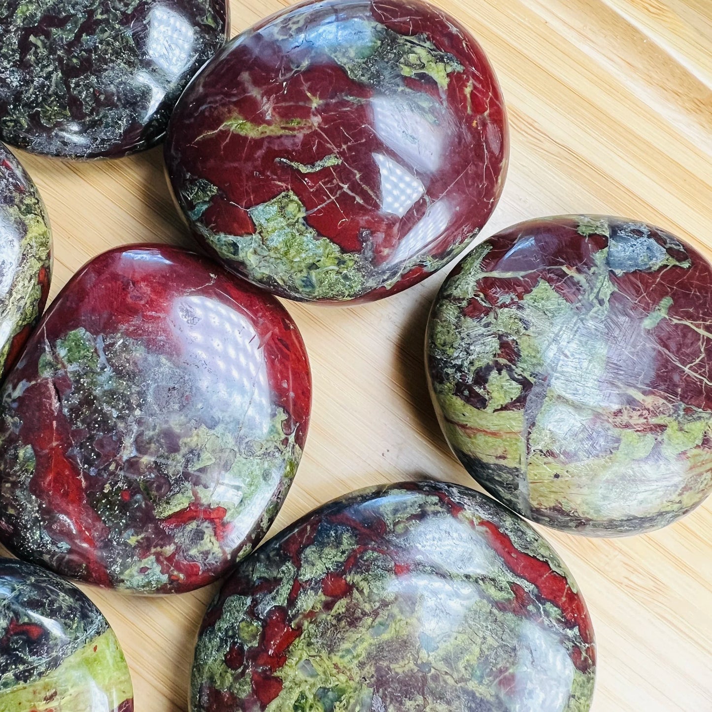 Opposite side of Grade AA Dragon Bloodstone palm stone, sourced from South Africa.