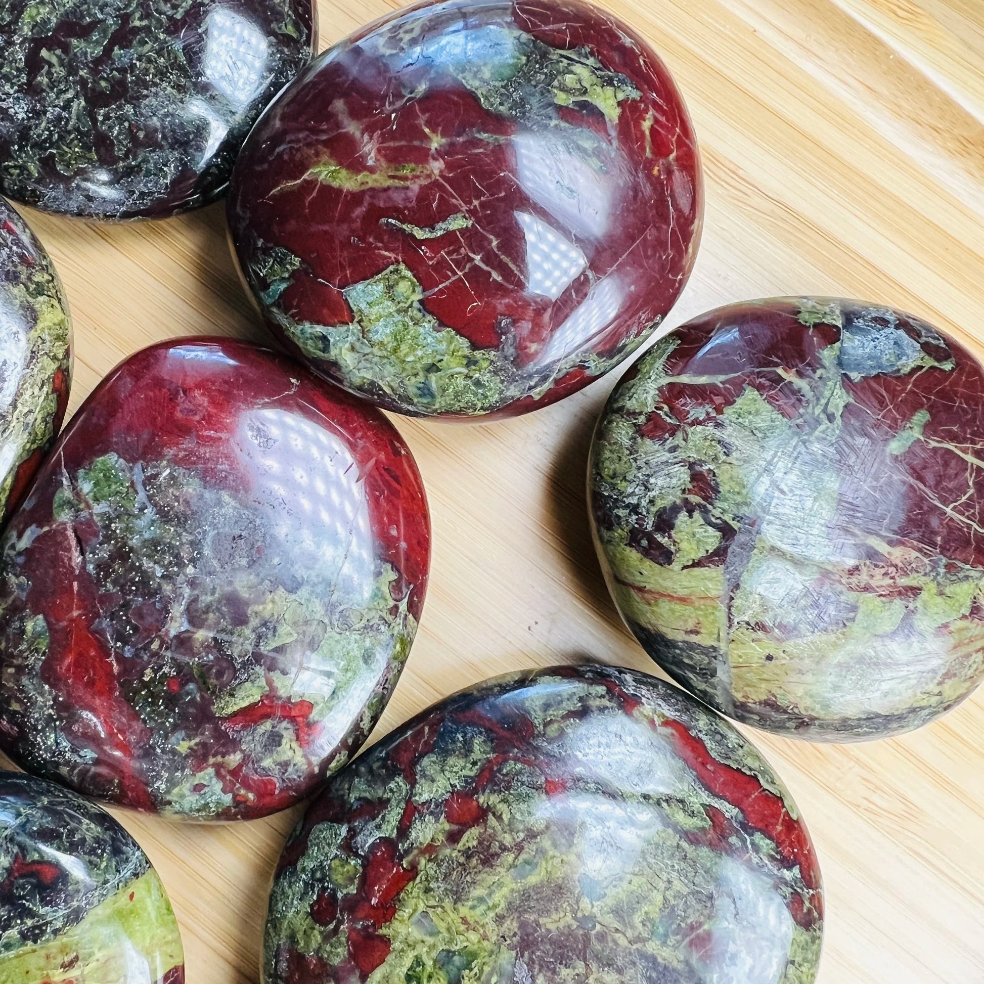 Opposite side of Grade AA Dragon Bloodstone palm stone, sourced from South Africa.