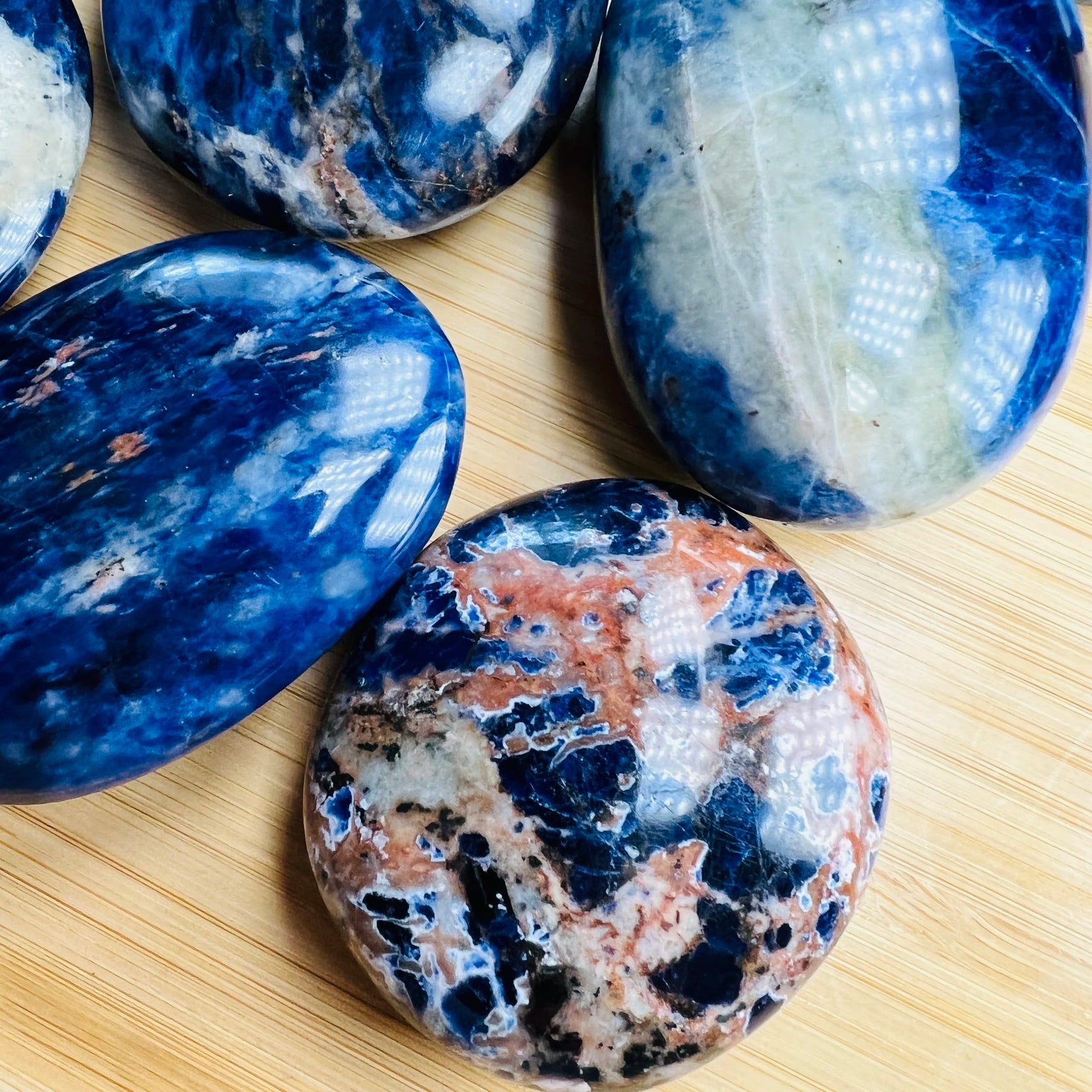 Bottom side of Grade AA Sodalite palm stone, often kept for Focus and Intuition, Namibia-sourced.