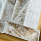 Detail shot of Grade AAA Selenite raw crystals under natural light