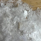 Back view of Grade AAA Selenite crystal chips showing natural surface