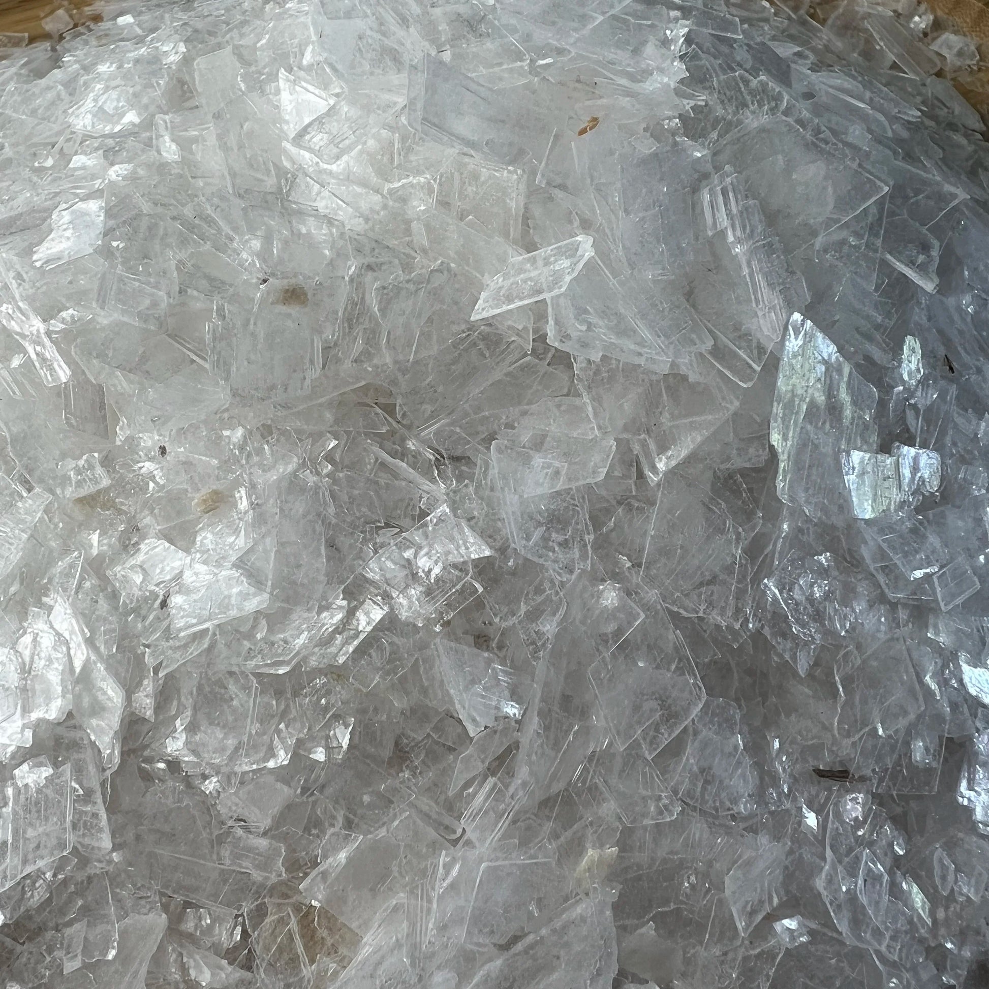Detail shot of Grade AAA Selenite crystal chips under natural light