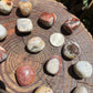 Detail shot of Grade AA Crazy Lace Agate tumbled stone under natural light