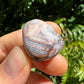 Close-up detail of Grade AA Crazy Lace Agate tumbled stone showing natural multicolored tones and texture