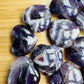 Edge view of Amethyst polished heart, kept close for Stress Relief and Sleep, showing translucent edges.