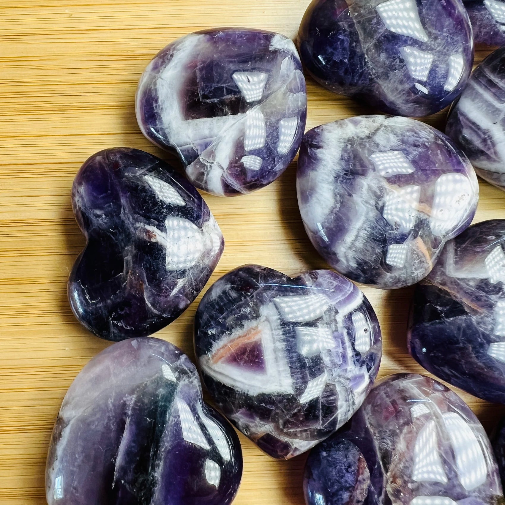 Edge view of Amethyst polished heart, kept close for Stress Relief and Sleep, showing translucent edges.