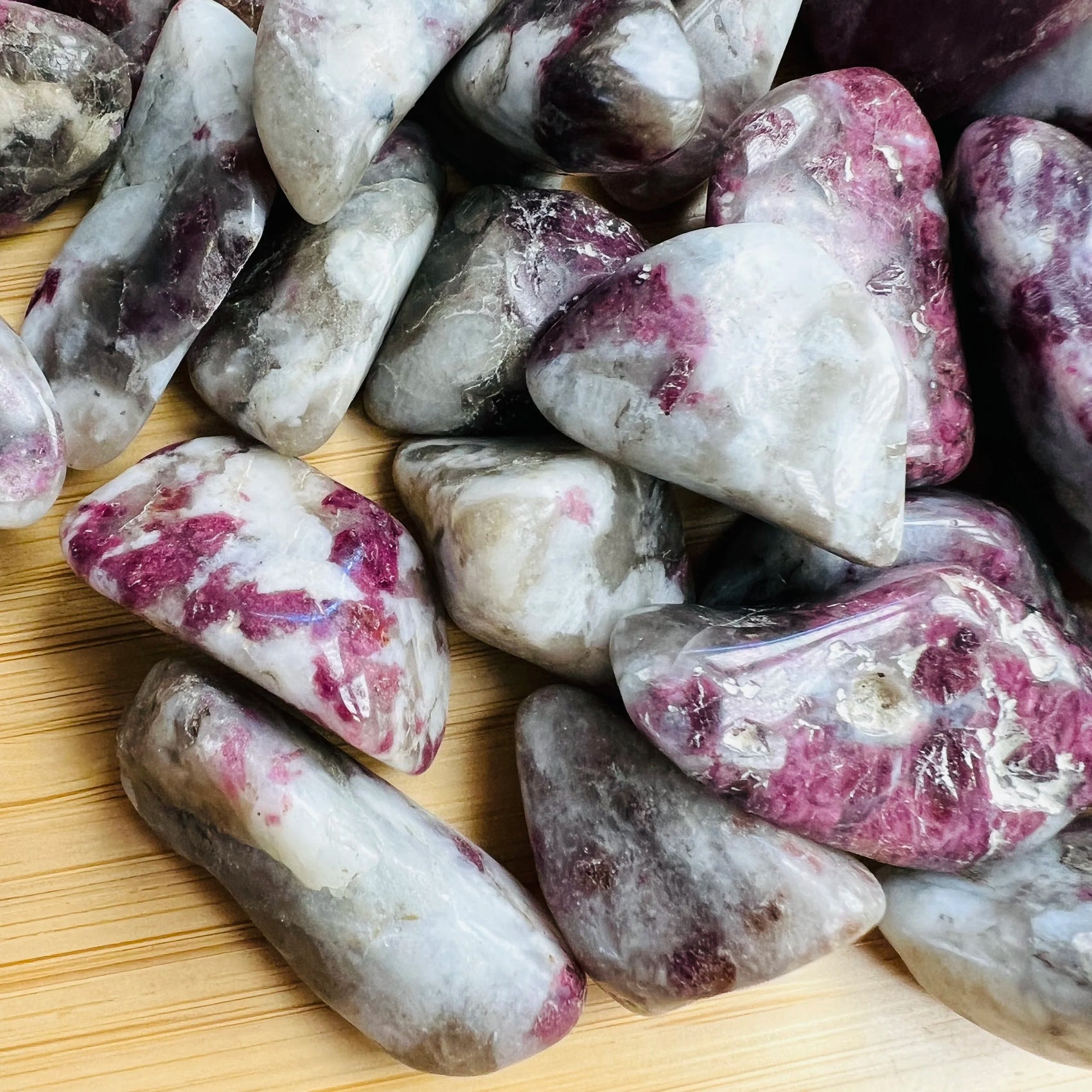 Detail shot showing Pink Tourmaline tumbled stone, Madagascar-sourced, associated with Love.