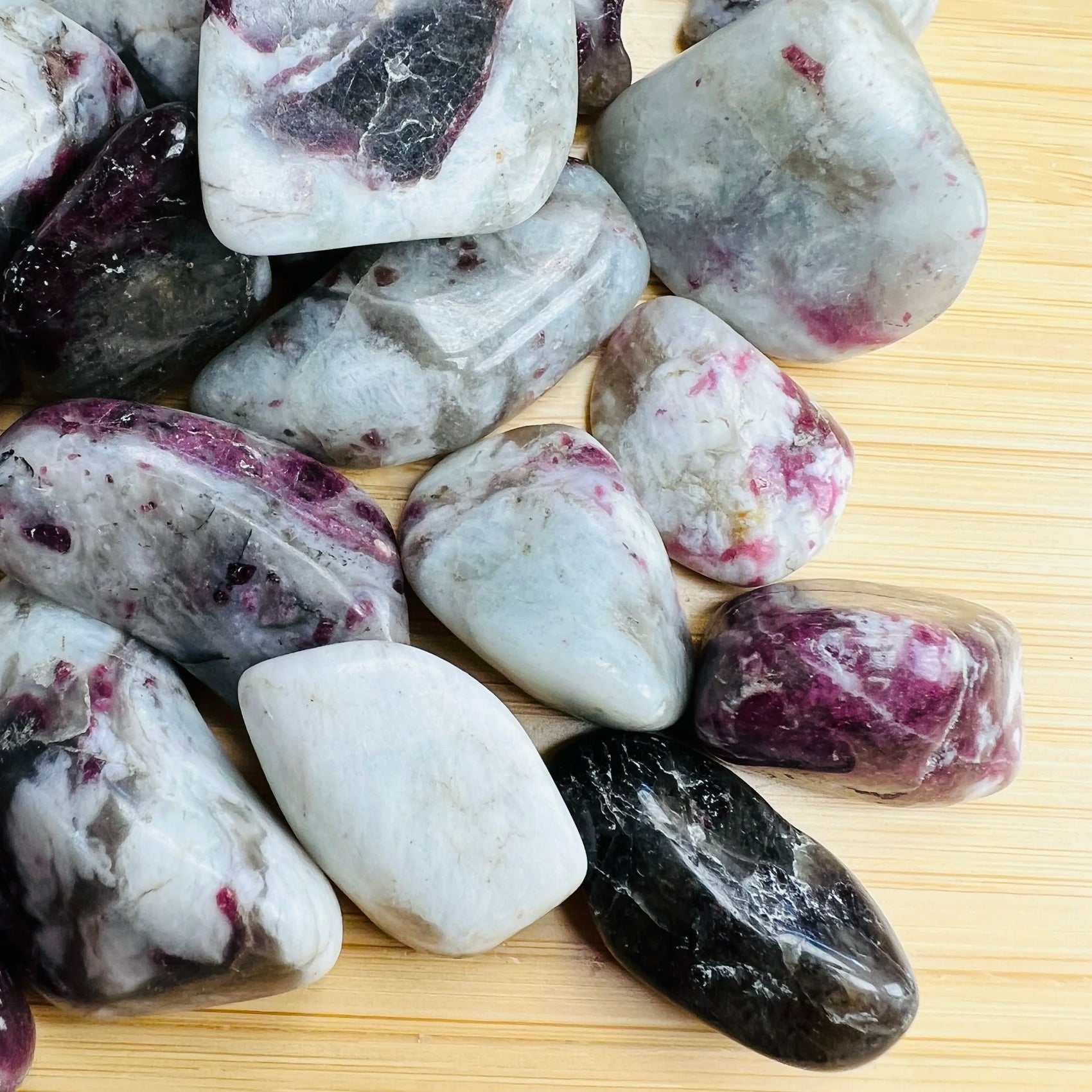 Top view of Pink Tourmaline tumbled stone, showing matte finish.