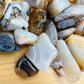 Plan view of Dendritic Agate tumbled stone, showing natural sheen, often kept for Grounding.